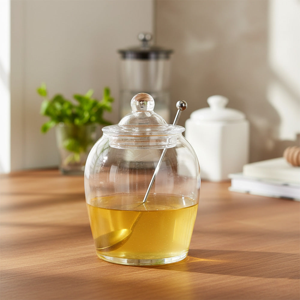جرة زجاجية مع غطاء وملعقة